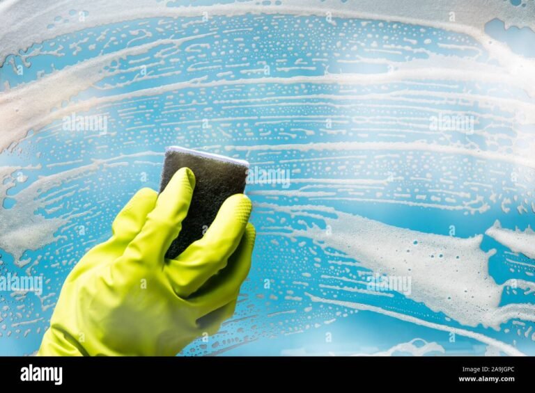 Cuánto Cuesta y Cómo Funciona la Limpieza a Domicilio por Horas 11 persona limpiando ventana con guantes y esponja